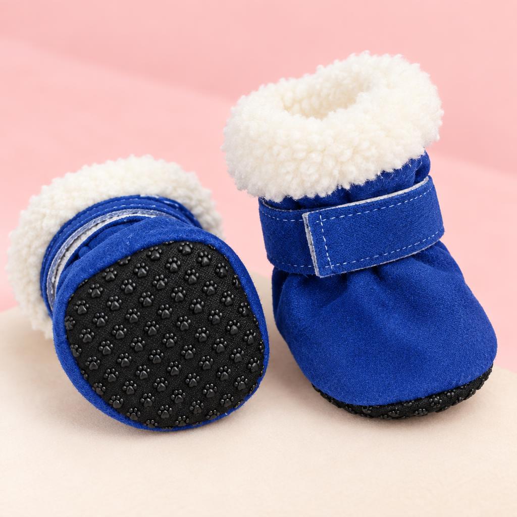 Close-up of the blue fleece-lined anti-slip dog boots on a soft pink background