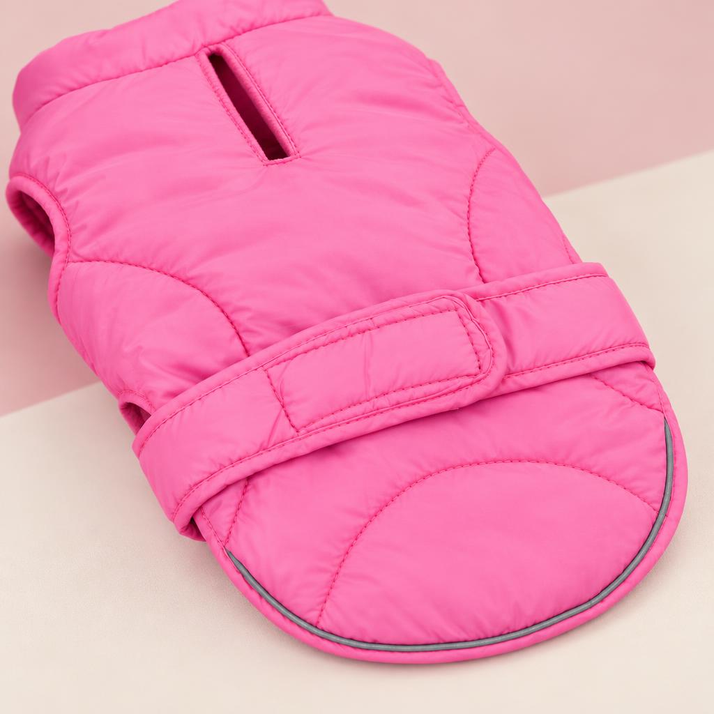 Close-up of the pink reflective padded dog jacket on a soft pink background