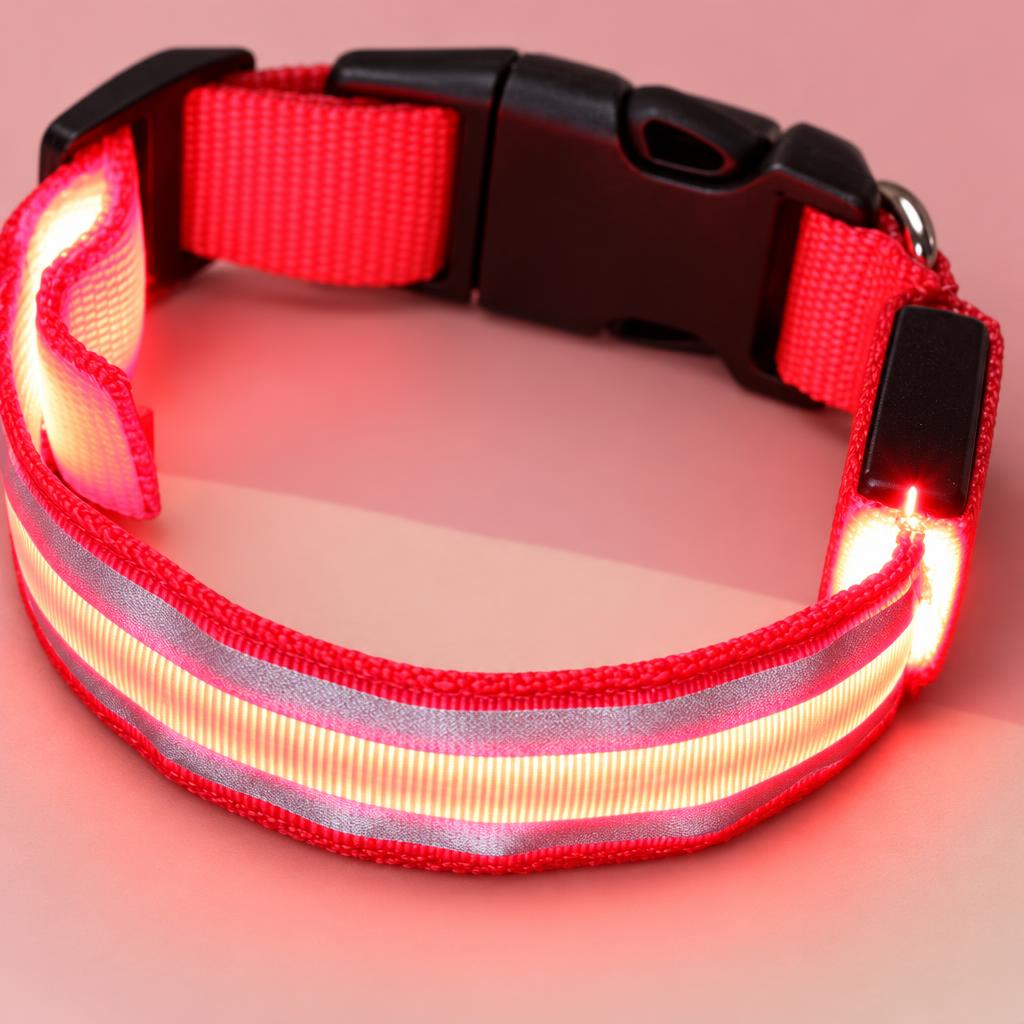 Close-up of the red LED light-up dog collar on a soft pink background
